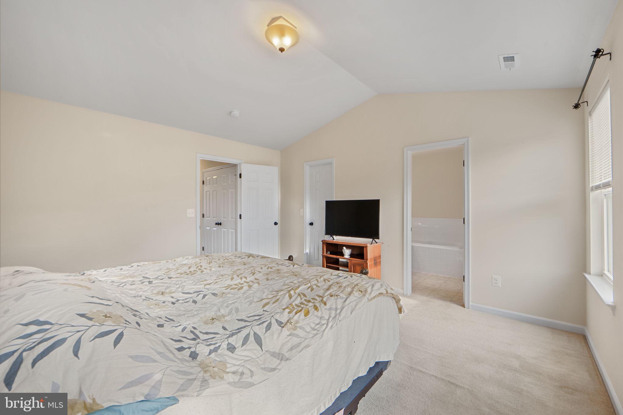 2210 Mallard Landing Drive Fredericksburg, VA 22408 - Photo 20 of 30 a bedroom with a bed and a flat tv screen on wall