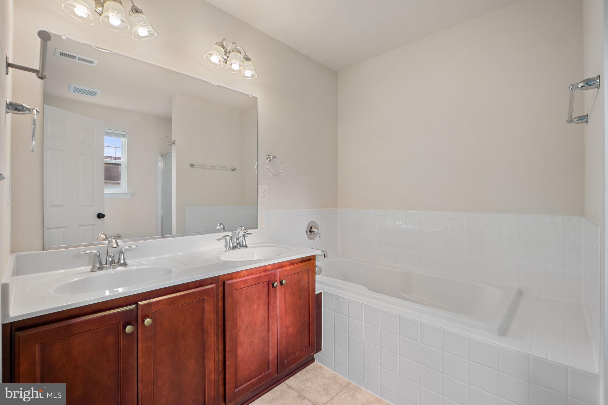 2210 Mallard Landing Drive Fredericksburg, VA 22408 - Photo 21 of 30 a bathroom with a tub sink double and mirror