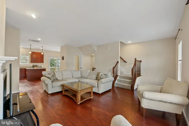 a living room with furniture and kitchen view