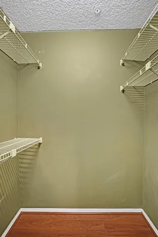 a view of a room with wooden floor