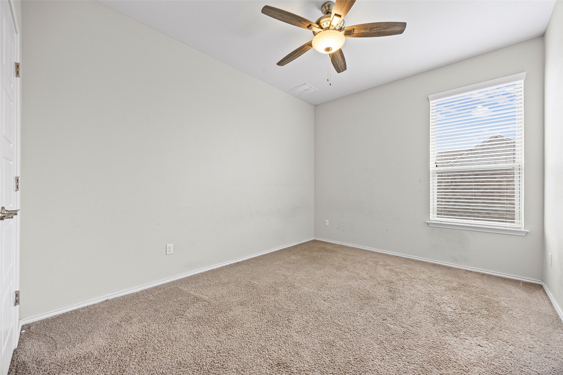17401 Silent Harbor Loop Pflugerville, TX 78660 - Photo 31 of 37 Carpeted empty room with a ceiling fan and baseboards