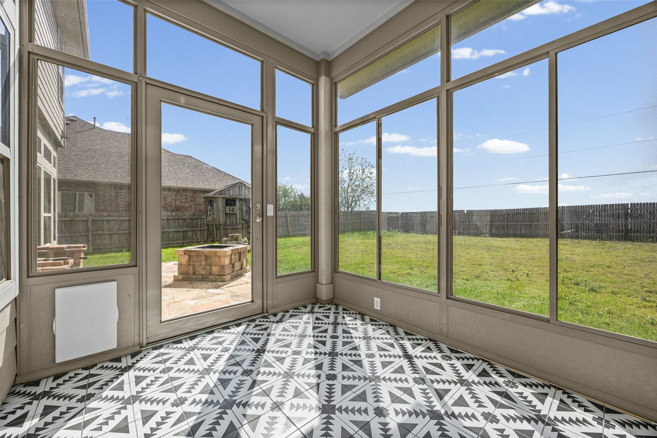 17401 Silent Harbor Loop Pflugerville, TX 78660 - Photo 34 of 37 Unfurnished sunroom with a fire pit and plenty of natural light