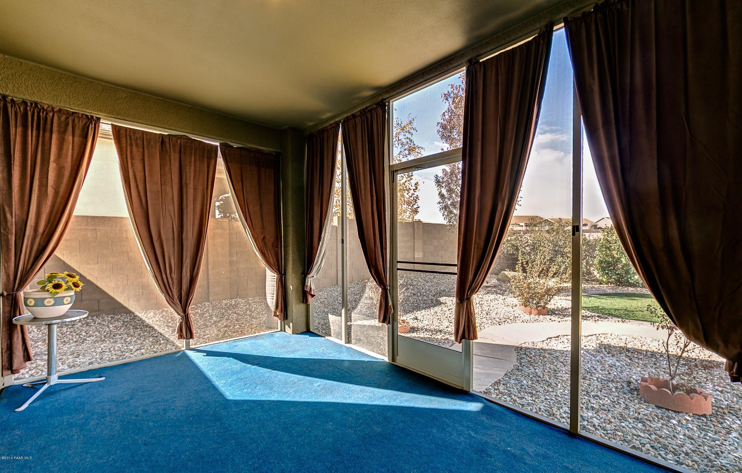 4728 Edgemont Road Prescott Valley, AZ 86314 - Photo 15 of 17 a view of an empty room with wooden floor and a window