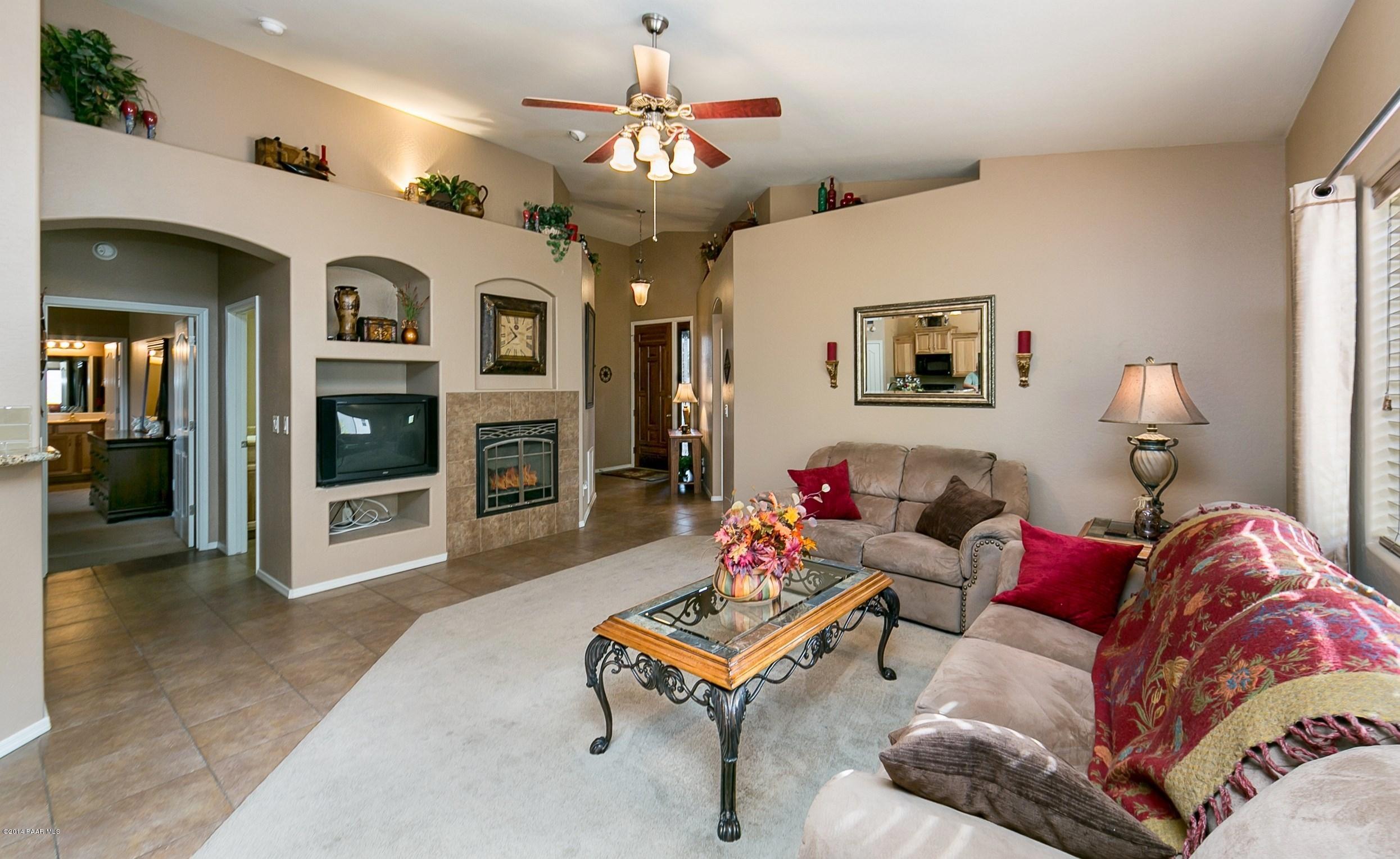 4728 Edgemont Road Prescott Valley, AZ 86314 - Photo 5 of 17 a living room with furniture and a fireplace