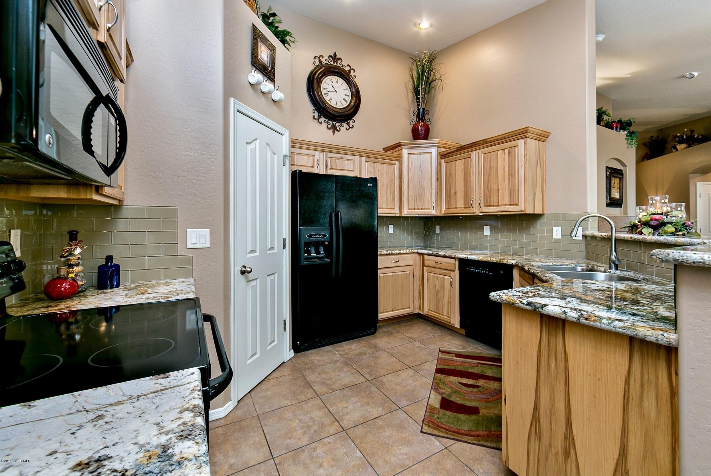 4728 Edgemont Road Prescott Valley, AZ 86314 - Photo 6 of 17 a kitchen with a stove cabinets and a refrigerator