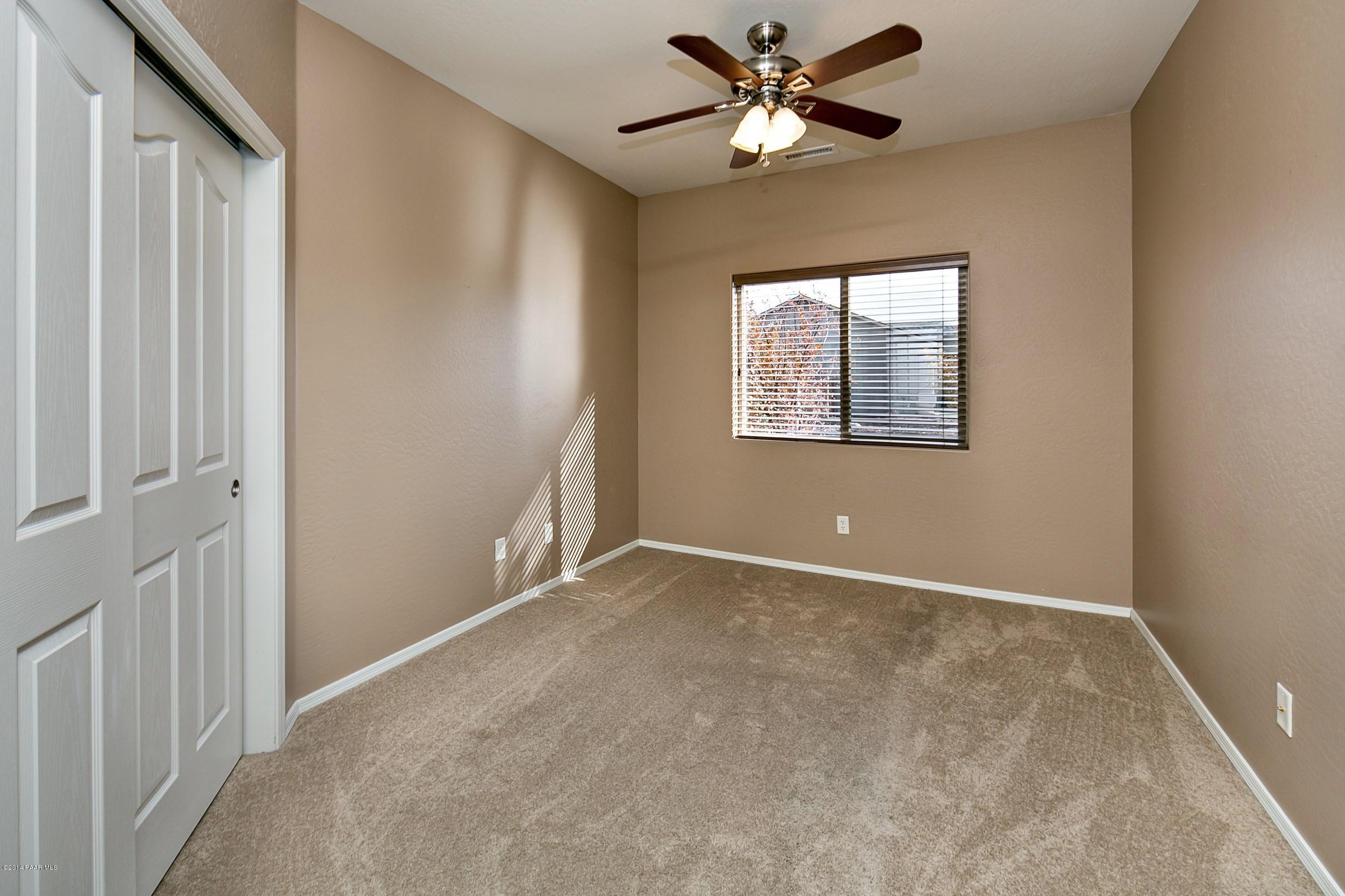 4728 Edgemont Road Prescott Valley, AZ 86314 - Photo 10 of 17 an empty room with windows and fan