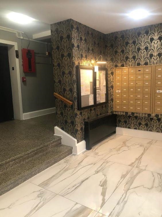 165 Vroom Street, Unit 1F Jersey City, NJ 07306 - Photo 2 of 11 a bathroom with double vanity and a bathtub