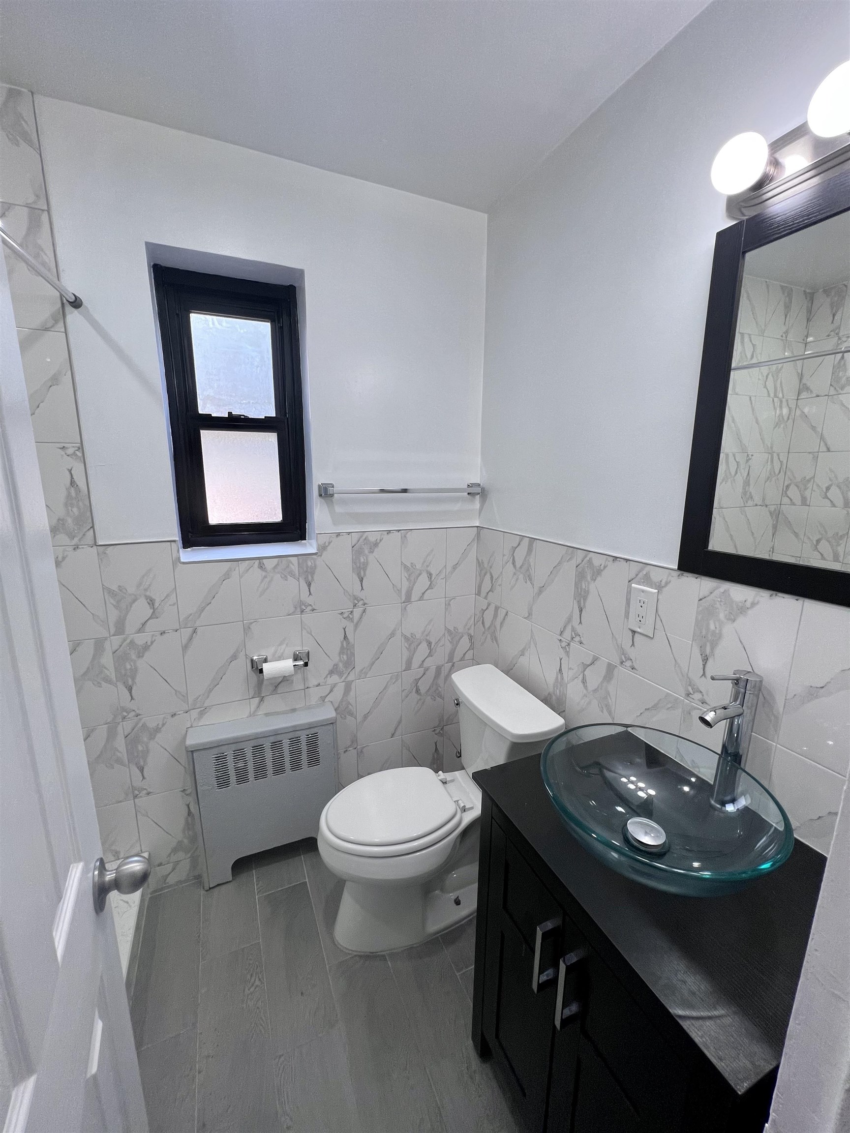 165 Vroom Street, Unit 1F Jersey City, NJ 07306 - Photo 5 of 11 a bathroom with a sink a toilet and mirror