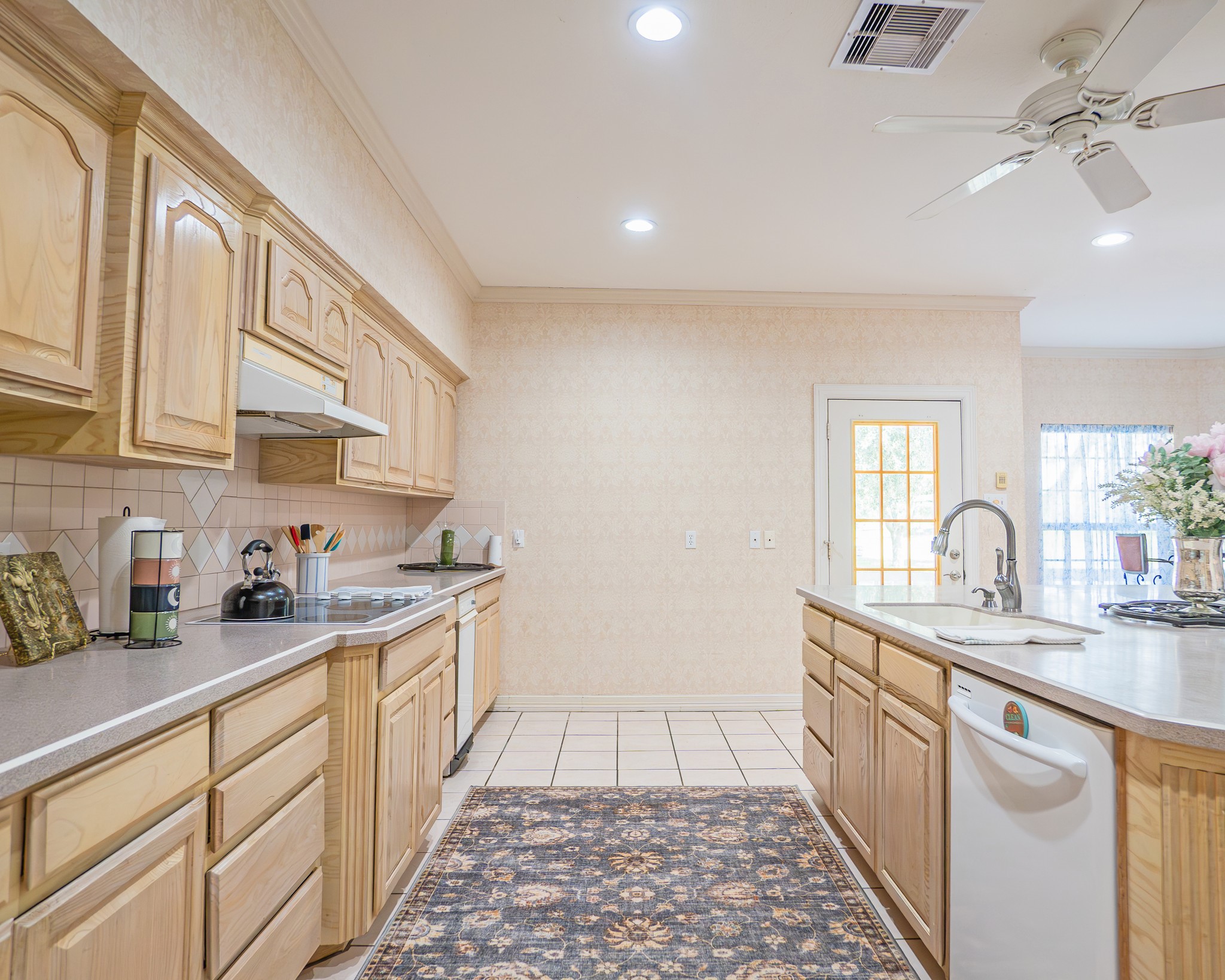 214 Williams Road Bay City, TX 77414 - Photo 33 of 48 a kitchen with a sink dishwasher and white cabinets with wooden floor