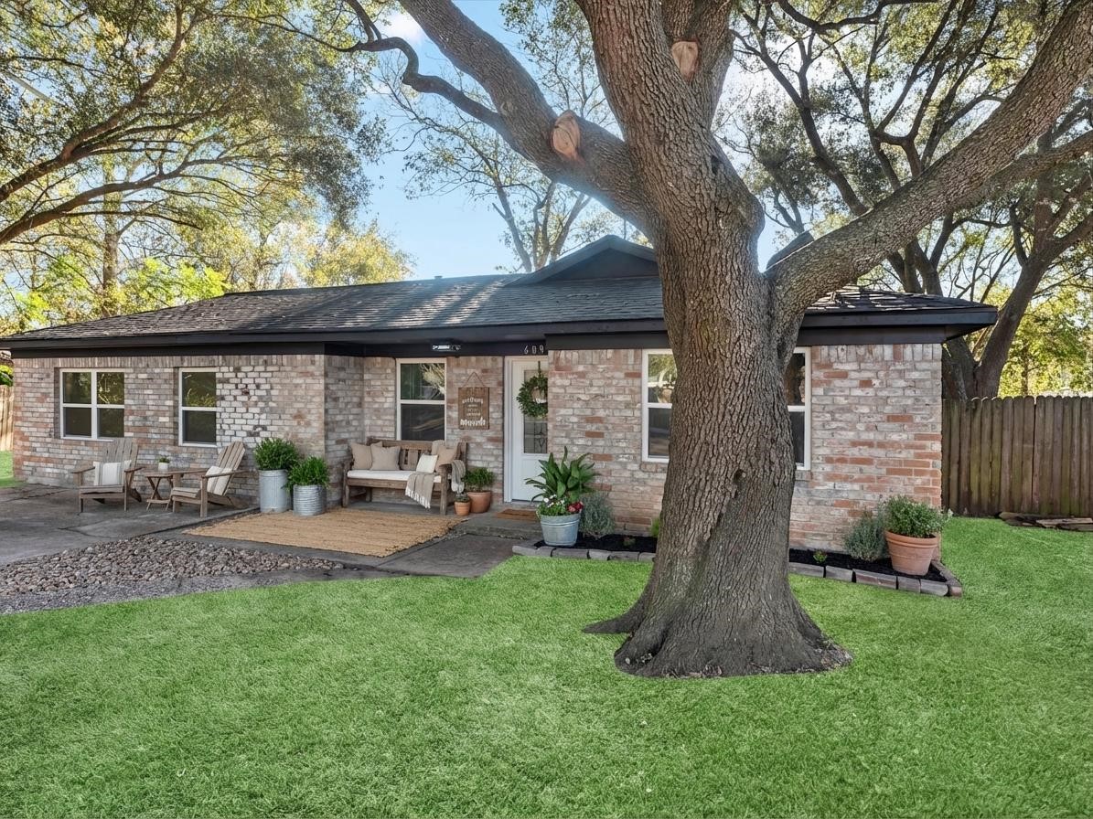 a front view of a house with porch and garden
