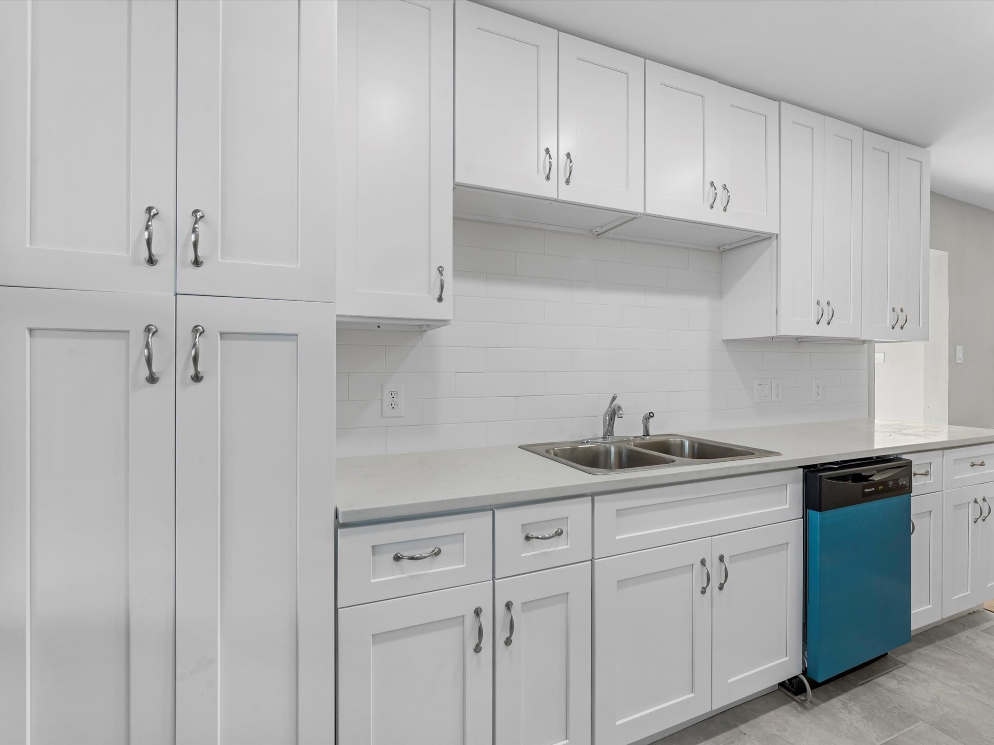 609 Debbie Lane Alvin, TX 77511 - Photo 11 of 23 a kitchen with white cabinets and a sink