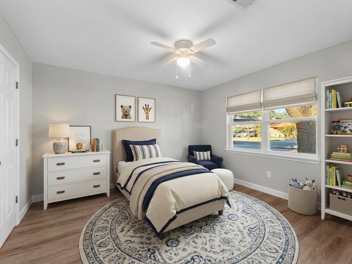 609 Debbie Lane Alvin, TX 77511 - Photo 14 of 32 a bedroom with a bed and a window