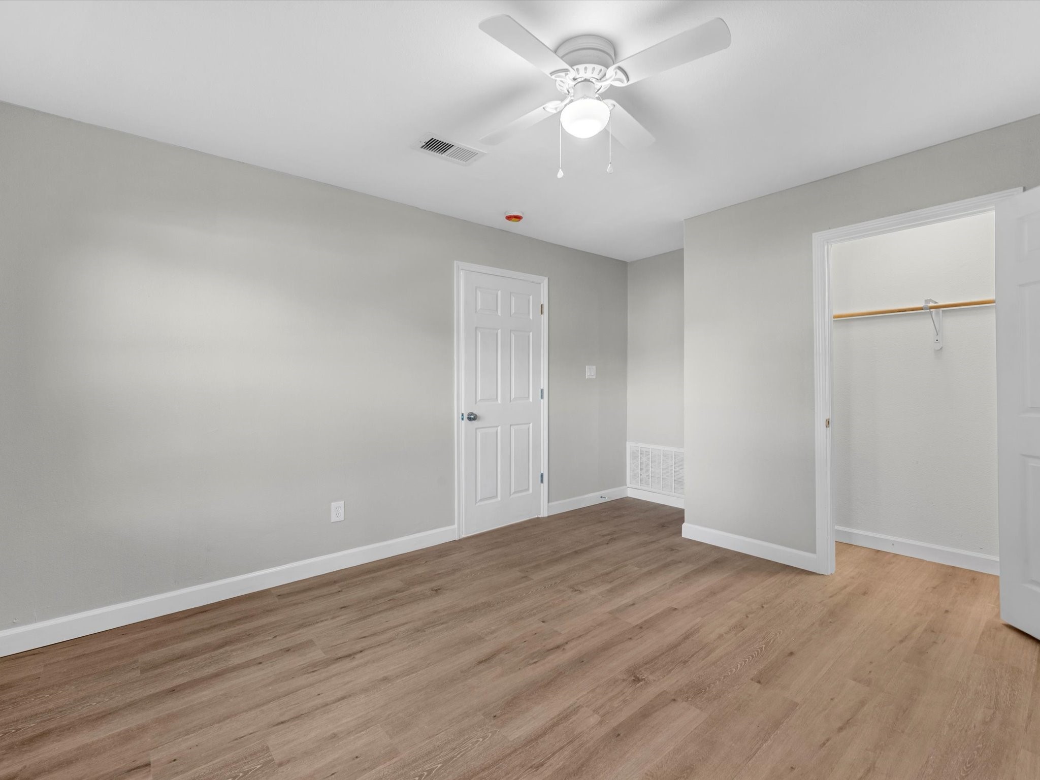 609 Debbie Lane Alvin, TX 77511 - Photo 15 of 23 an empty room with wooden floor and ceiling fan