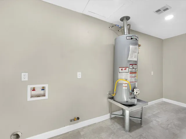 a view of a hallway with a room and wooden floor