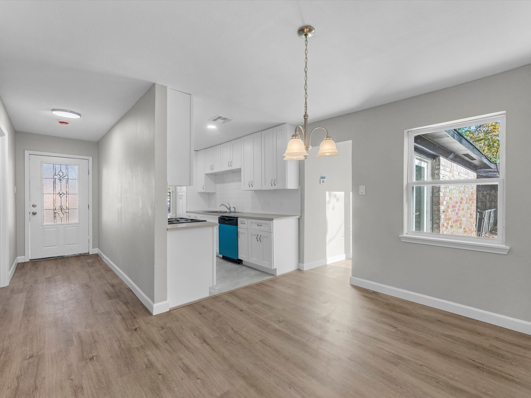 609 Debbie Lane Alvin, TX 77511 - Photo 3 of 23 a view of a kitchen with stainless steel appliances granite countertop wooden floors