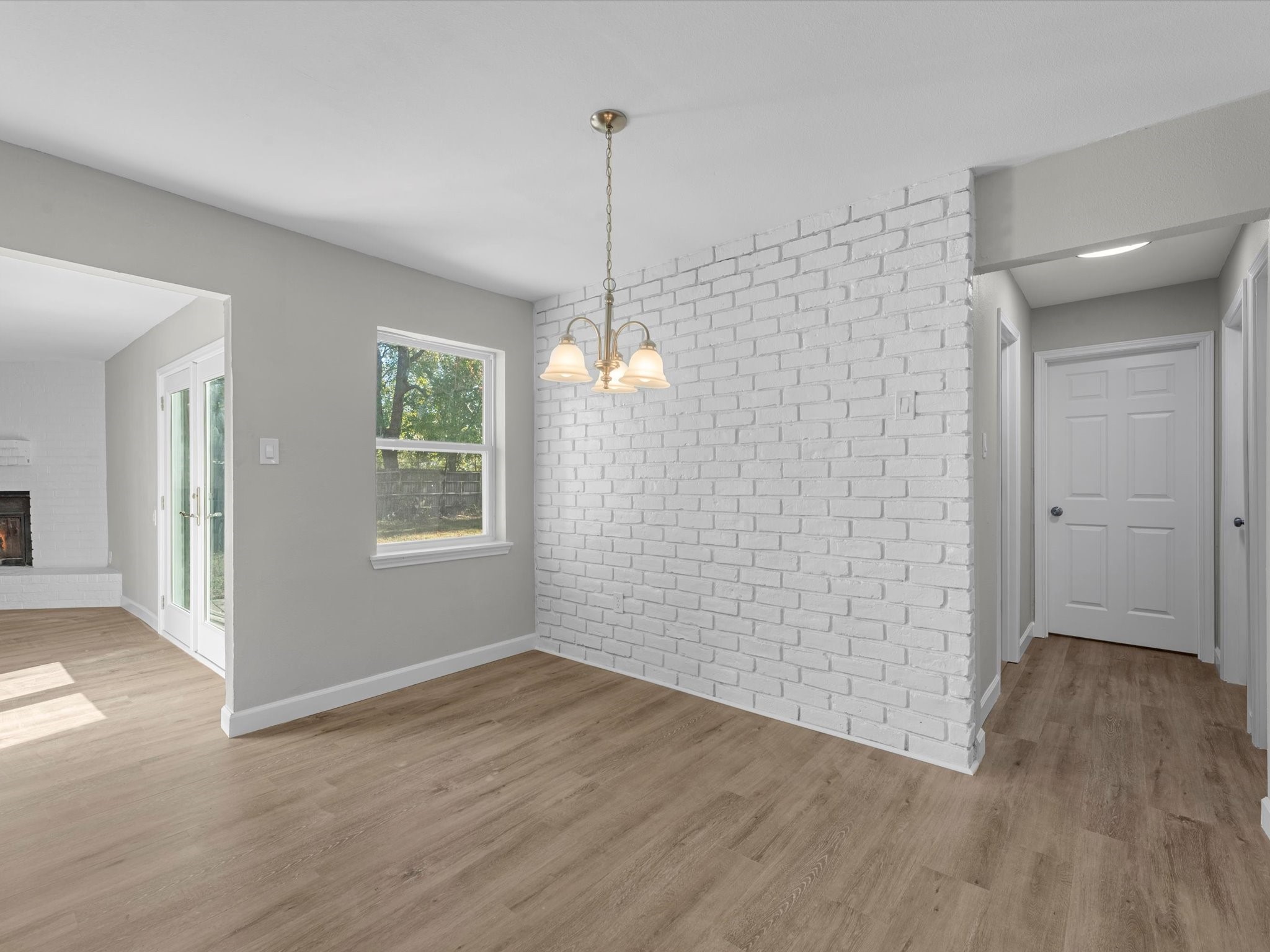 609 Debbie Lane Alvin, TX 77511 - Photo 4 of 23 a view of an empty room with wooden floor and a window