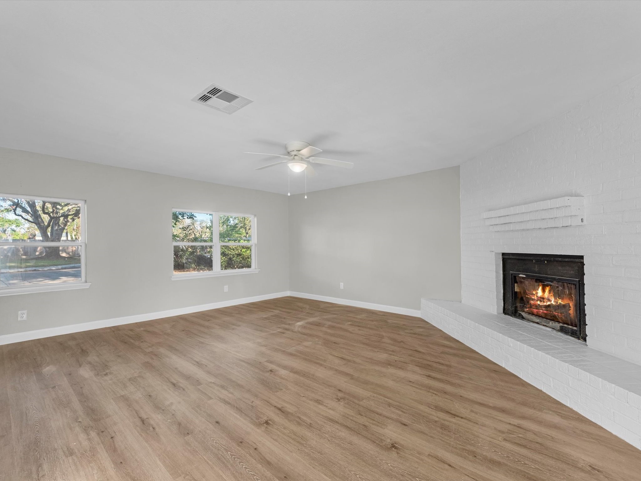 609 Debbie Lane Alvin, TX 77511 - Photo 5 of 23 an empty room with windows and fireplace