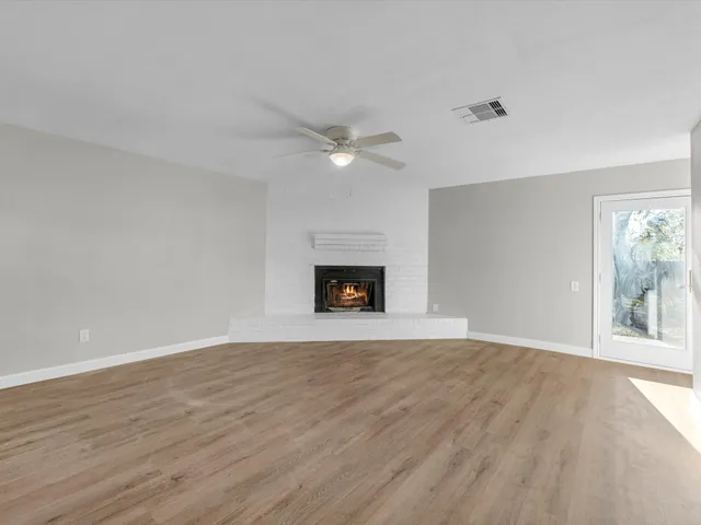 wooden floor in an empty room with a fireplace