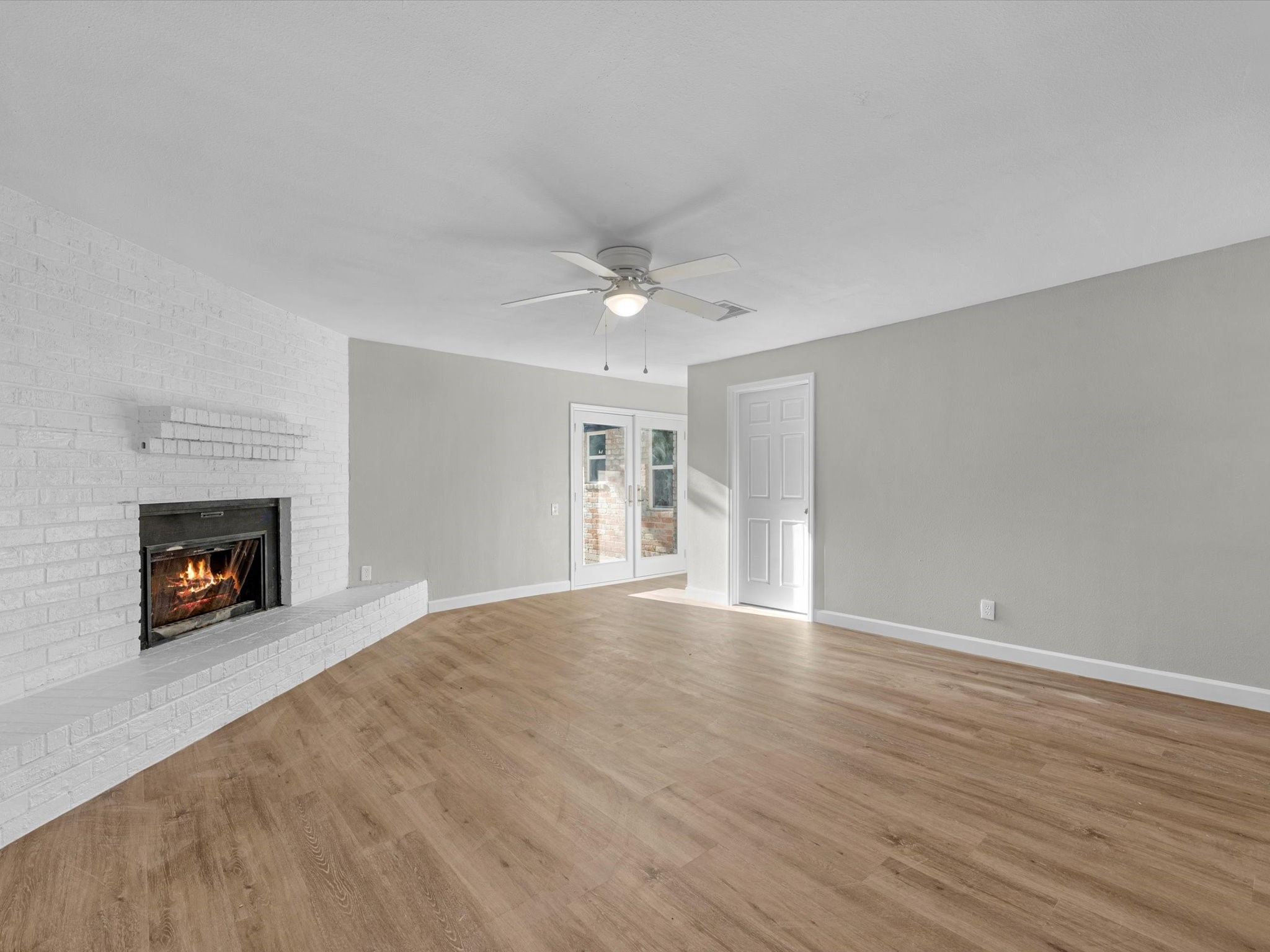 609 Debbie Lane Alvin, TX 77511 - Photo 7 of 23 a view of an empty room with a fireplace and a window