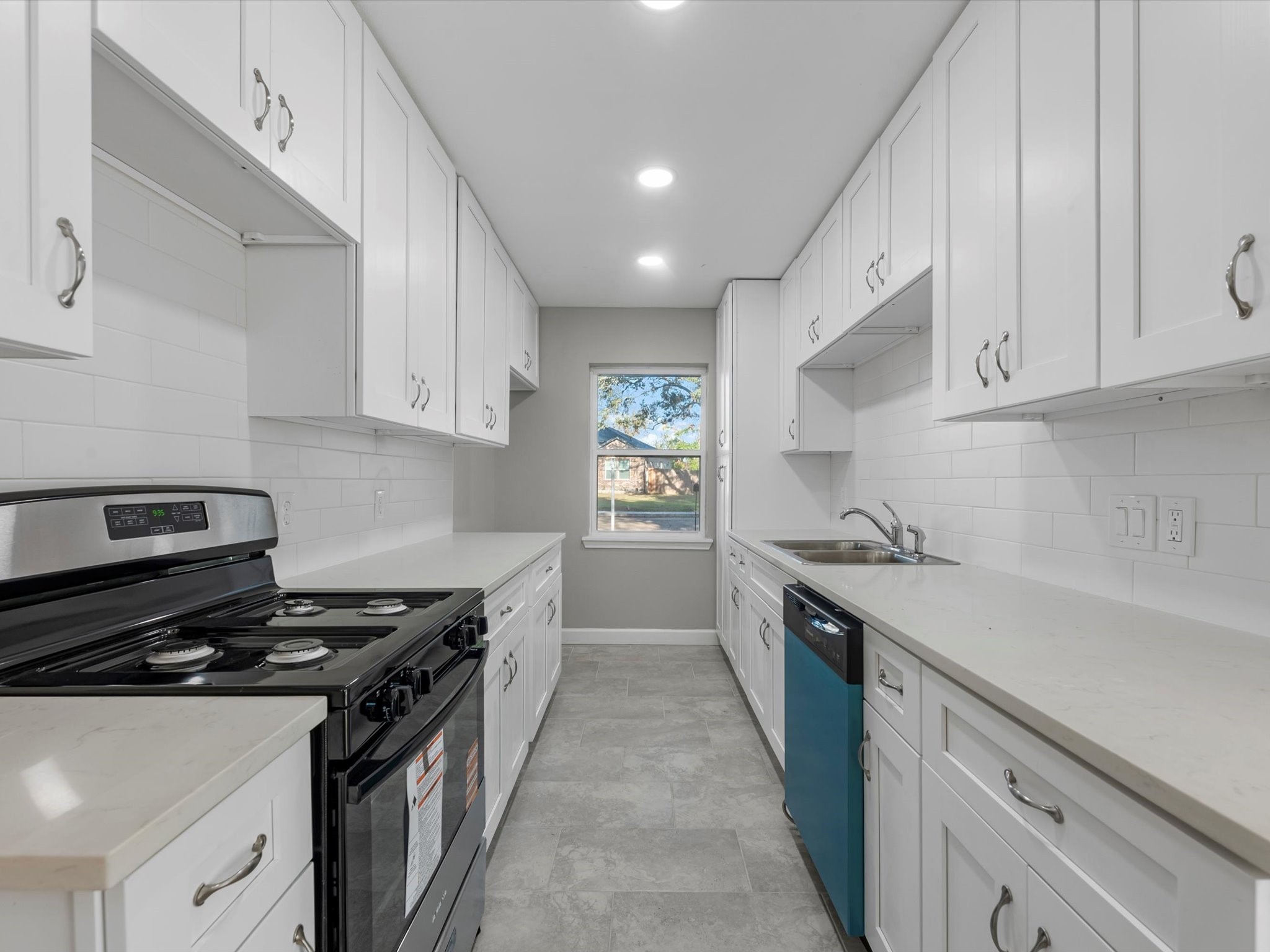 609 Debbie Lane Alvin, TX 77511 - Photo 9 of 23 a kitchen with granite countertop a sink a stove and cabinets