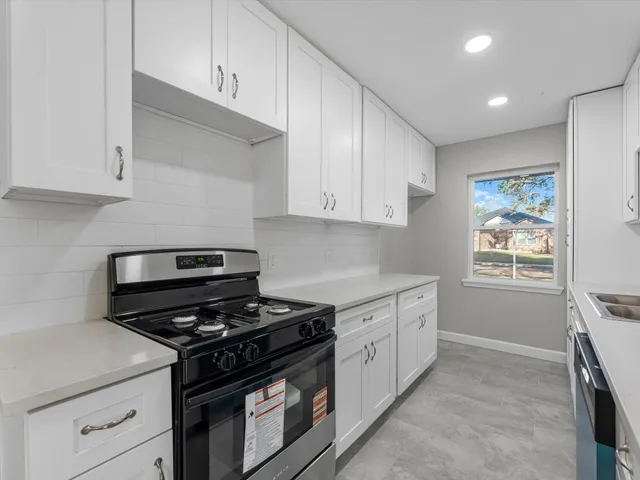 a stove top oven sitting inside of a kitchen
