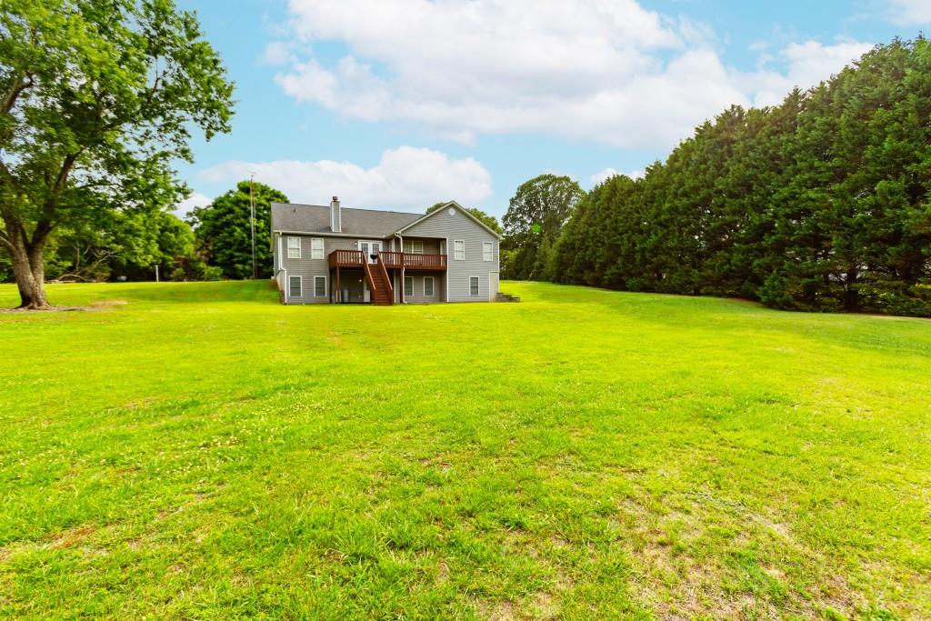 1042 Harbins Road Dacula, GA 30019 - Photo 24 of 35 a view of a large pool with an outdoor space and seating area
