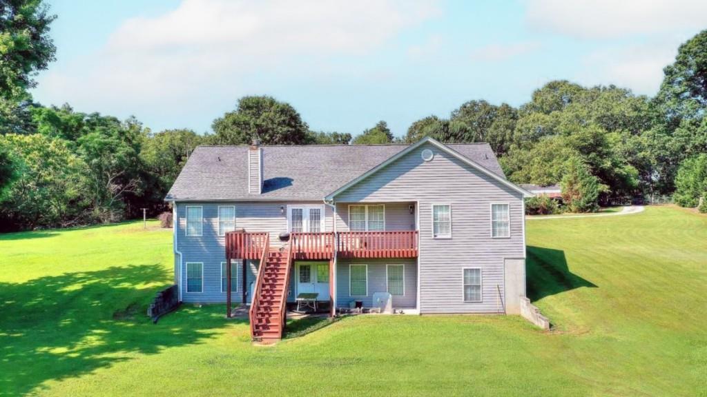 1042 Harbins Road Dacula, GA 30019 - Photo 5 of 35 a view of a house with a yard potted plants and a tree