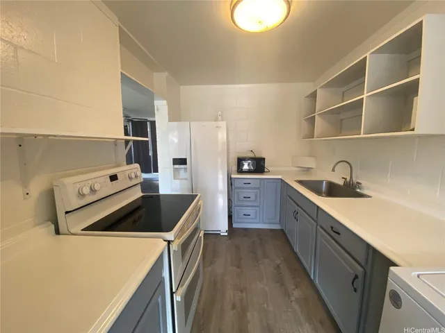 a kitchen with cabinets and steel stainless steel appliances
