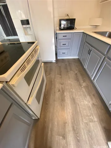 a kitchen with a sink and a stove top oven