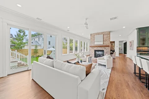 a living room with fireplace furniture and a large window