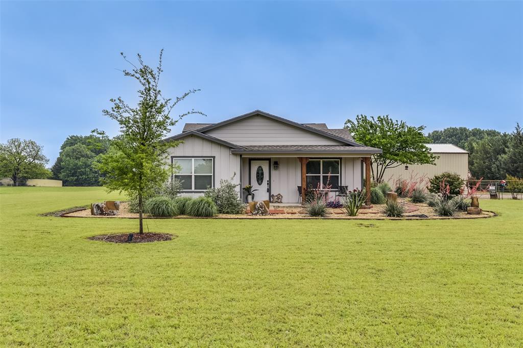 2683 Bells Chapel Road Palmer, TX 75152 - Photo 2 of 30 a front view of a house with garden and porch