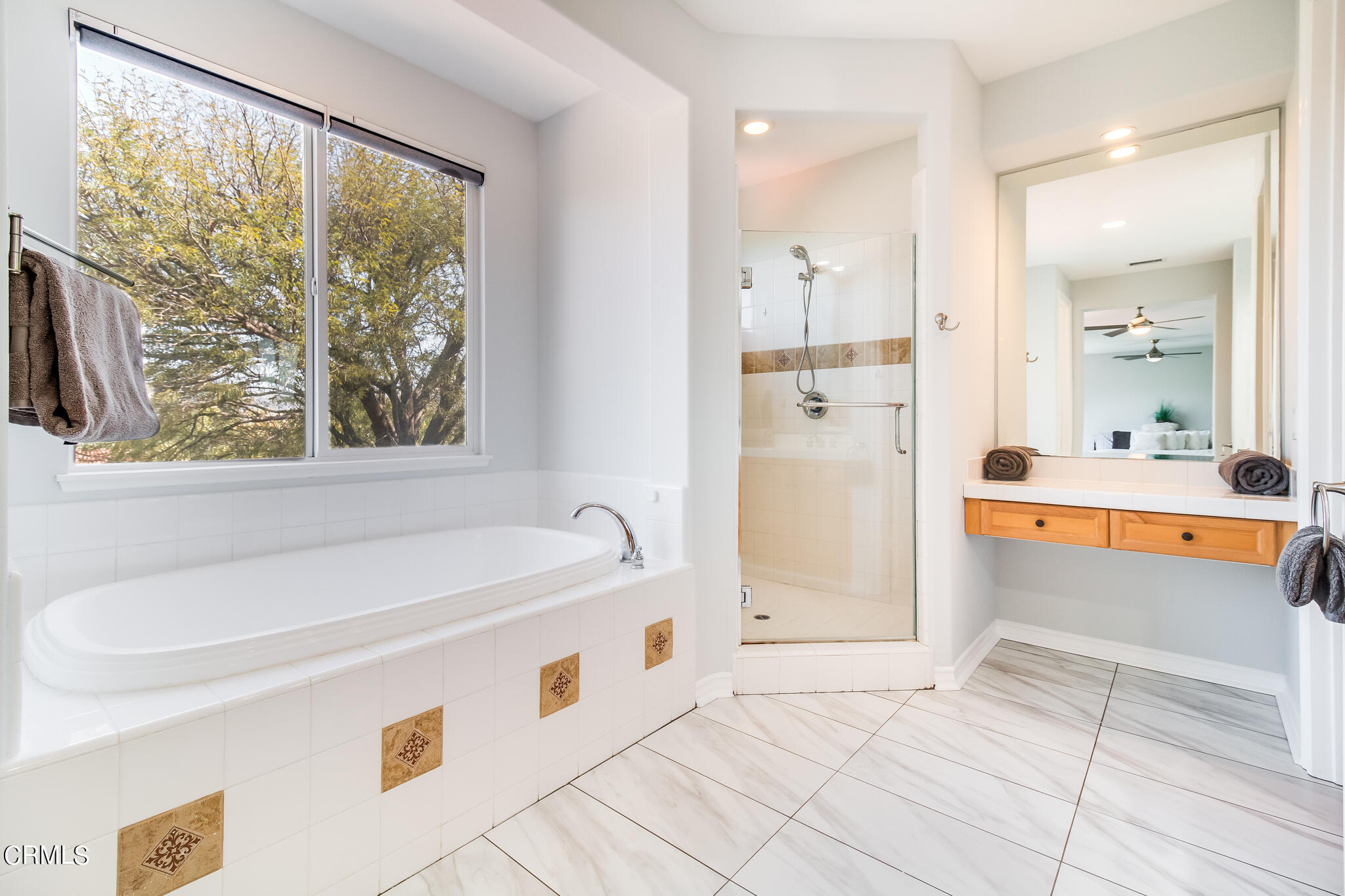13625 Silver Oak Lane Moorpark, CA 93021 - Photo 20 of 44 a bathroom with a tub a sink and a large mirror