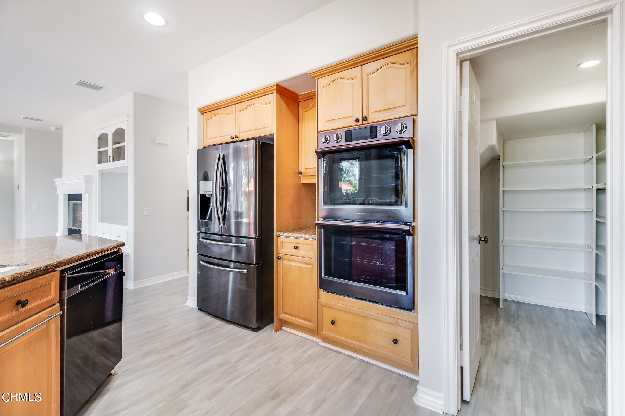 13625 Silver Oak Lane Moorpark, CA 93021 - Photo 8 of 44 a kitchen with stainless steel appliances granite countertop a refrigerator and a stove top oven