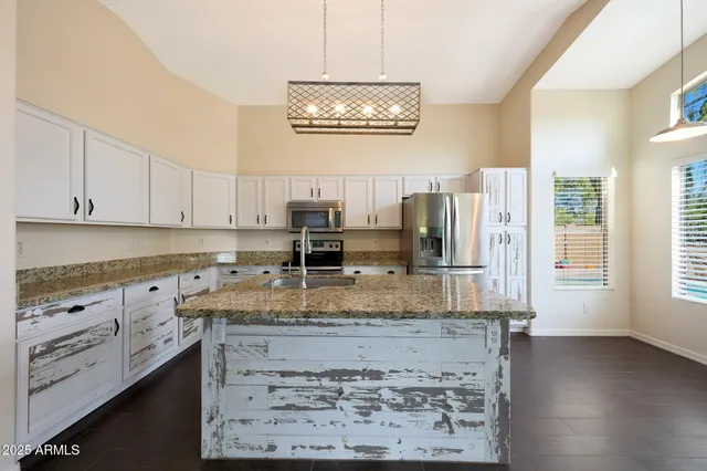 a backyard of a house with barbeque oven and outdoor seating