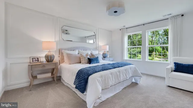 a spacious bedroom with a bed and a couch