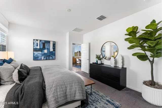 a bedroom with a bed and a night stand