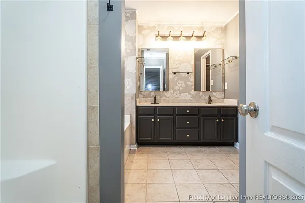 a bathroom with a granite countertop sink a mirror and a vanity