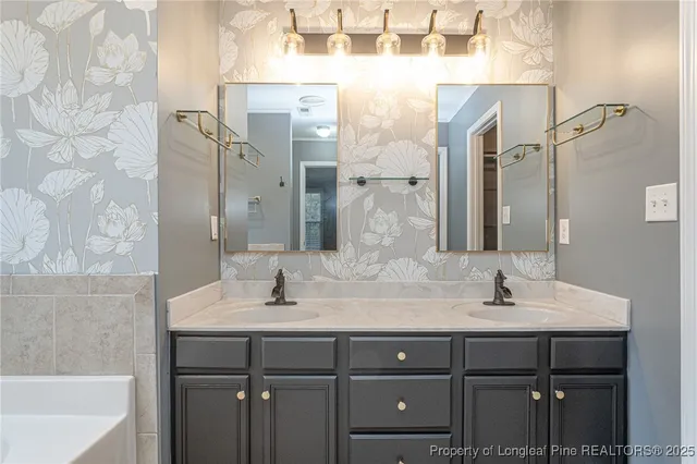 a bathroom with a granite countertop sink a mirror and a bathtub