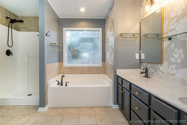 a bathroom with a tub sink and mirror