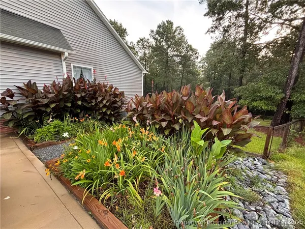 a view of a house with a flower garden