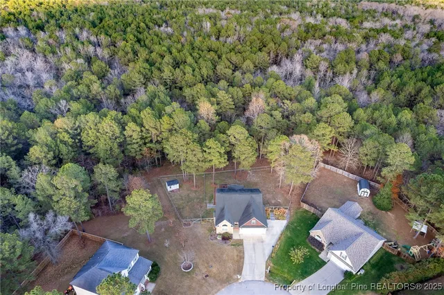 an aerial view of a house with yard