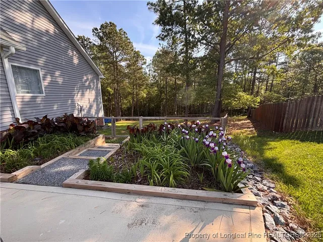 a view of a back yard with flower plants