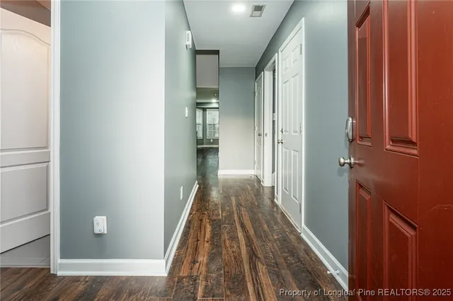 a view of hallway with wooden floor