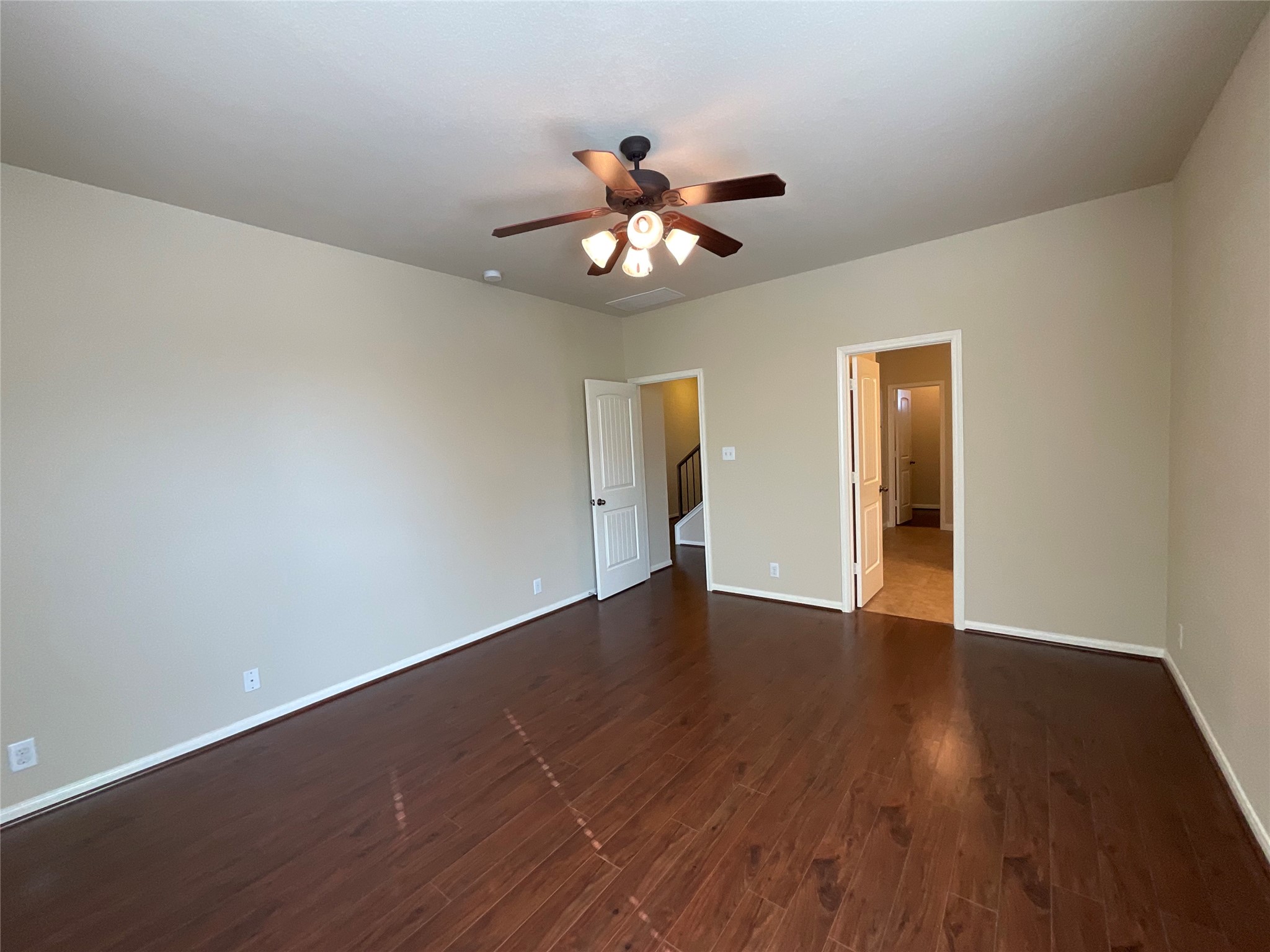 1911 Conn Creek Road Cedar Park, TX 78613 - Photo 27 of 39 a view of an empty room with wooden floor and a ceiling fan