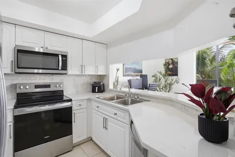 a kitchen with a stove microwave and sink