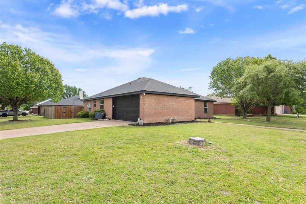10817 Lilry Road Waco, TX 76708 - Photo 2 of 27 View of property exterior with brick siding, driveway, and an attached garage
