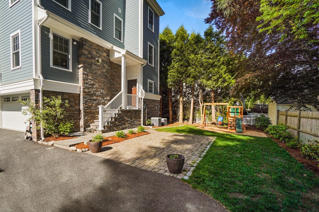 a view of a house with backyard and sitting area