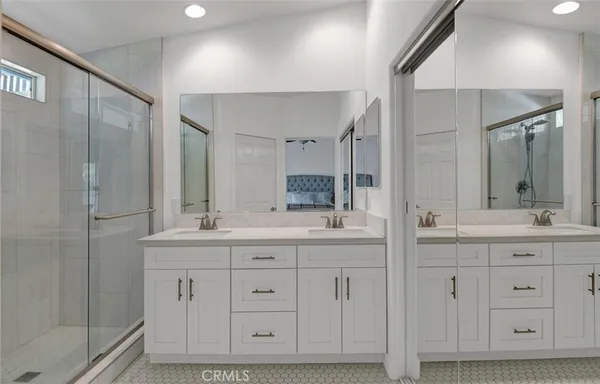 a bathroom with a granite countertop sink mirror and double