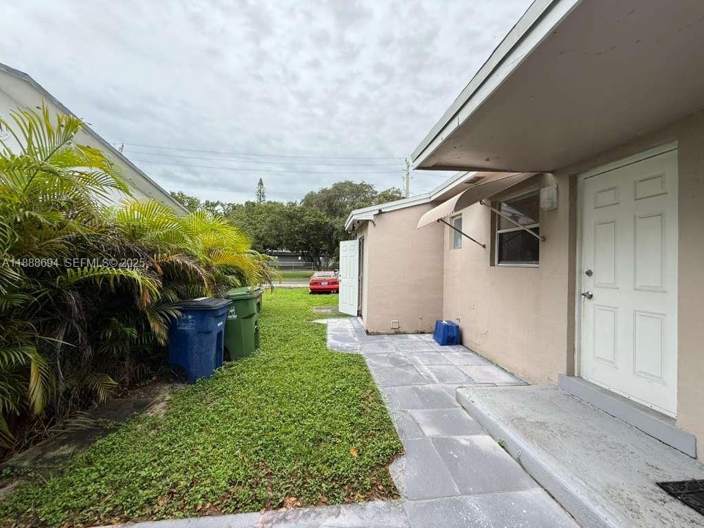 1049 Southwest 3rd Street Hallandale Beach, FL 33009 - Photo 11 of 15 a backyard of a house with lots of green space