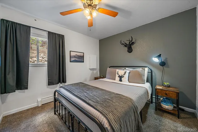 a bedroom with a large bed and a chandelier
